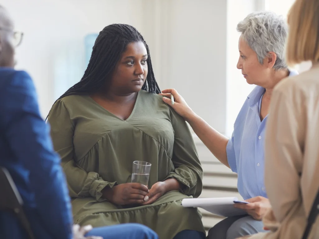 A diverse group in a supportive therapy session representing holistic DUI treatment that combines mental health support and substance abuse counseling for long-term healing.