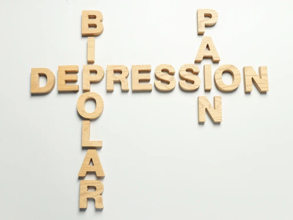 Letter tiles spelling out "depression," "bipolar," and "pain," symbolizing the connection between mental health struggles and DUI behavior.