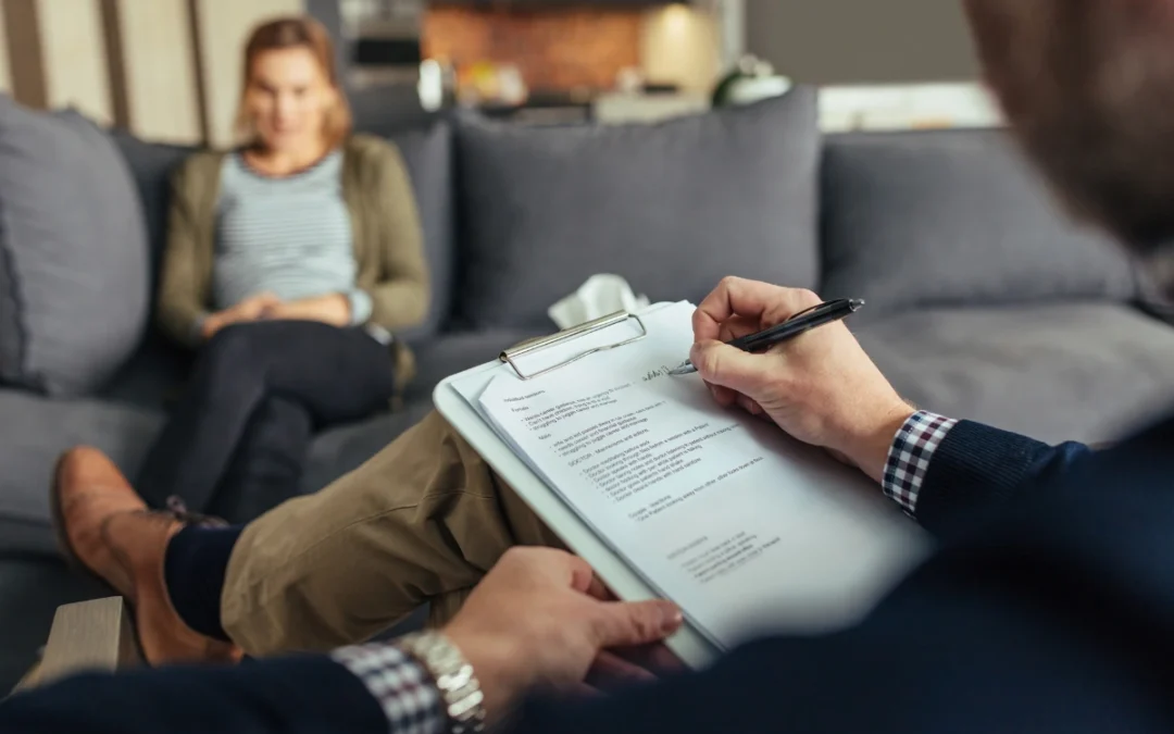 A young woman sits in a therapy session, focused on her recovery.