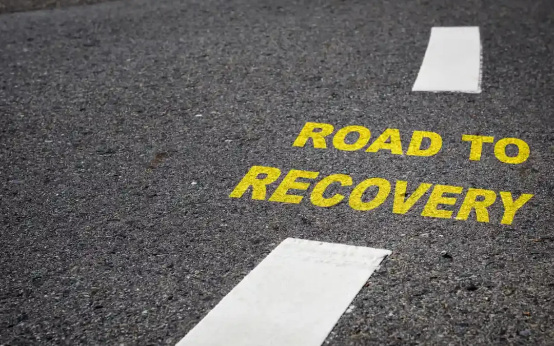 A road stretching into the distance with “Road to Recovery” written across it.