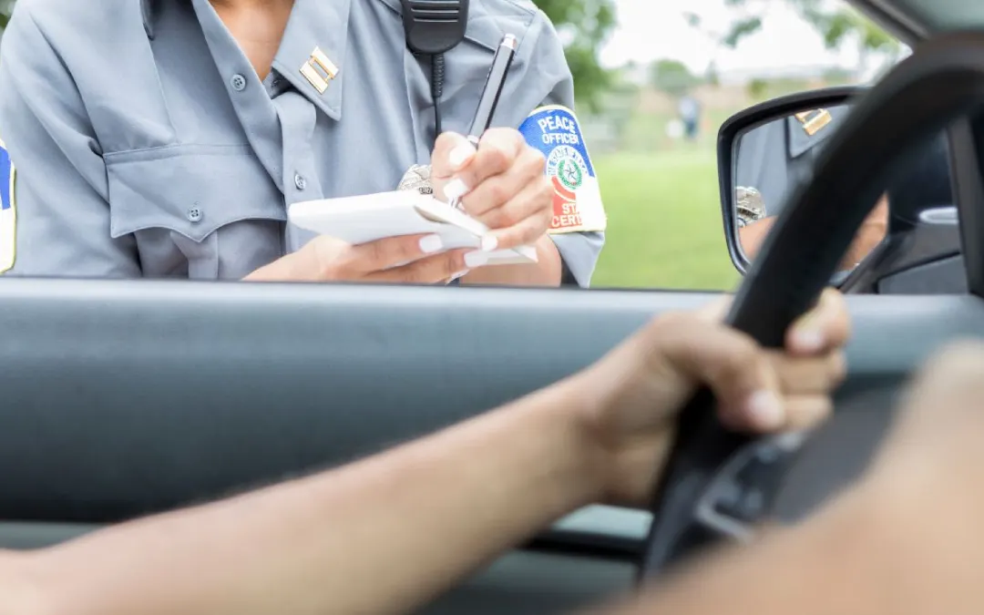 A woman stopped by a female police officer for a driving violation